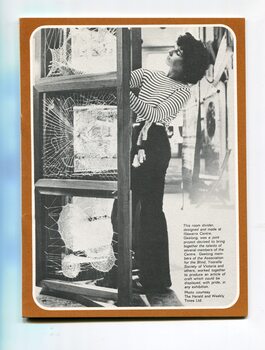 A young woman adjusts a woven room divider made by Illawarra Centre and Yooralla Society.