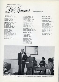 John King gives a Life Governor certificate to a woman whilst others look on and clap