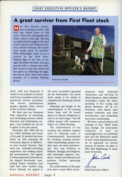 Hannah Annett stands with a milk pail, next to a dog and outside a falling down wooden shed