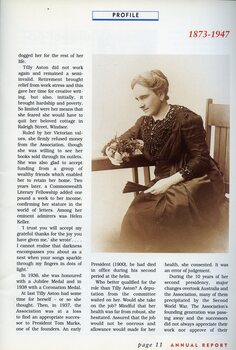 Portrait of Tilly Aston at a table, holding flowers and wearing gloves and a jet necklace.