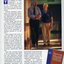 An older man acts as a sighted guide to another man along a corridor.