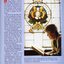 Beverley Dunn reads a book beneath the stained glass window of Shakespeare in the library.