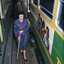 Winsome Baker walks between parked trams at the East Preston depot, using her white cane.
