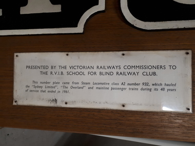 Cast iron train numbers mounted on wood with presentation plaque