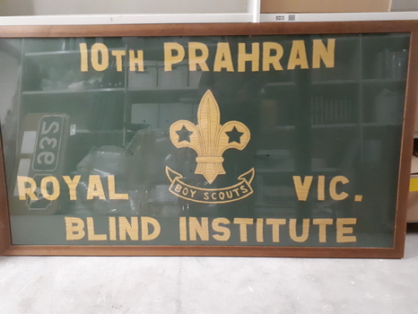 Green flag with yellow stitching in frame.
