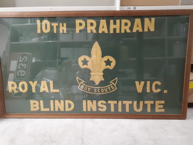 Green flag with yellow stitching in frame.