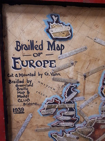 Map of Europe with metal plates labelled with Braille attached to map