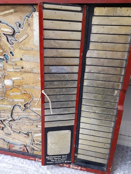 Fold out piece with metal labels brailled with names of countries