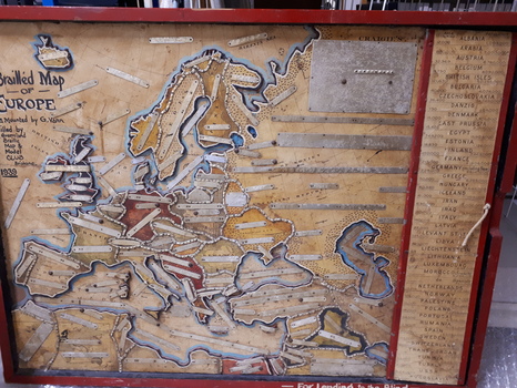 Map of Europe with metal plates labelled with Braille attached to map
