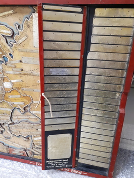 Fold out piece with metal plates brailled with country information