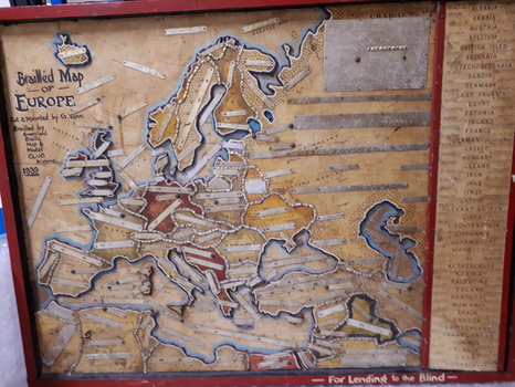 Map of Europe with metal plates labelled with Braille attached to map