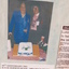 Two women stand with a decorated cake before them