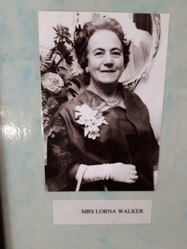 Lady in evening dress with corsage and long white gloves