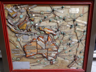 Map of Australia and pacific with metal lines and tags on various locations labelled with Braille