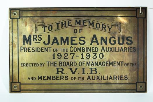 Gold coloured plaque with black writing