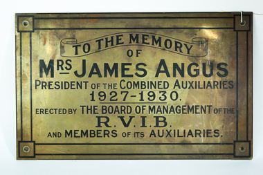 Gold coloured plaque with black writing