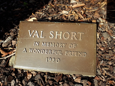Metal plaque with metal lettering in garden