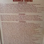 Blonde wooden board with maroon text