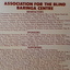 Blonde wooden board with maroon text
