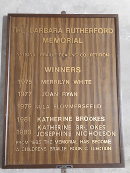 Brown laminate board with golden plastic lettering