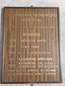 Brown laminate board with golden plastic lettering