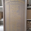 Grey wooden board with golden lettering