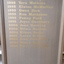 Grey wooden board with golden lettering