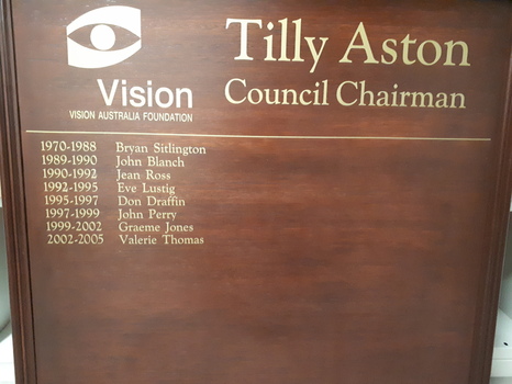 Brown board with gold lettering and raised edge