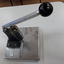 Metal sheet with ridges to align items above a punch activated by a lever pushed downwards