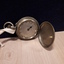 Silver watch with raised circles to indicate time