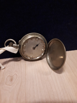 Silver watch with raised circles to indicate time