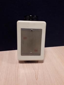 White rectangle with black dial on one side
