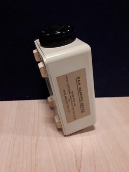 White rectangle with black dial on one side
