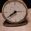 Gold clock with white clock face and black hands