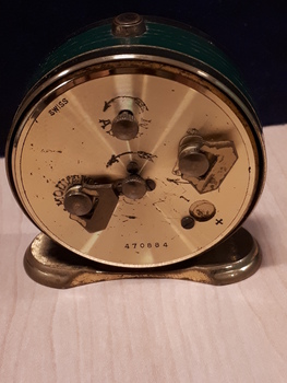 Rear of gold clock with winding mechanisms