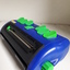 Blue rectangular shaped device with bright green buttons