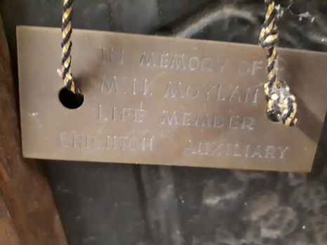 Metal plaque attached to firescreen