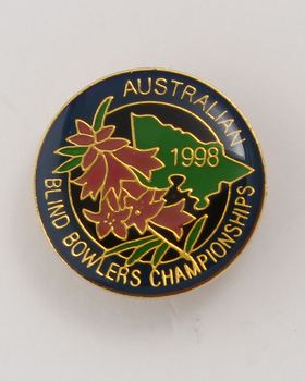 Round badge with 'Australian Blind Bowlers Championships 1988' in gold writing