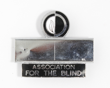 Silver badge with black and white guiding light logo