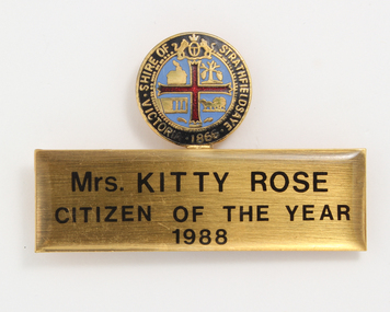 Strathfieldsaye coat of arms above gold rectangle incscribed Mrs Kitty Rose Citizen of the Year 1988