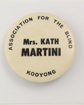 White button badge with black writing