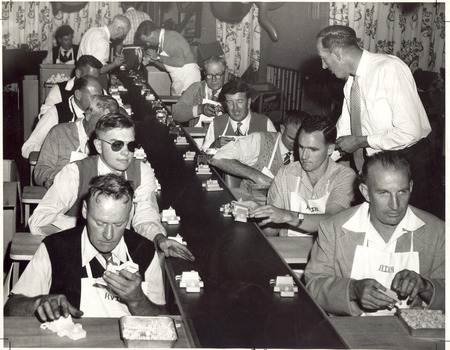 Two rows of men on an assembly line