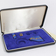 Open case with blue inlay and blue cloth medals with wattle on them