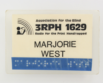 Laminated paper badge with braille tape added