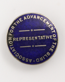 Round blue badge with silver writing