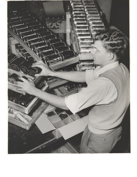 David Blyth stacking cans into cartons