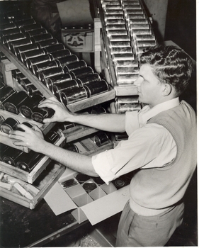 David Blyth stacking cans into cartons