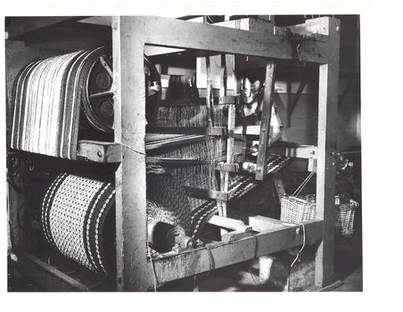 Man operating weaving machine for continuous matting