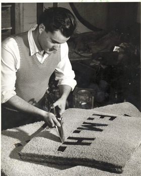 Man trimming a coir mat
