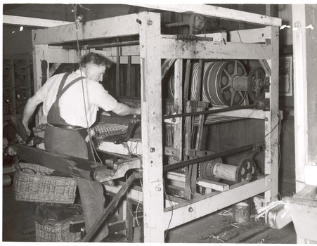Man operating mat making machine